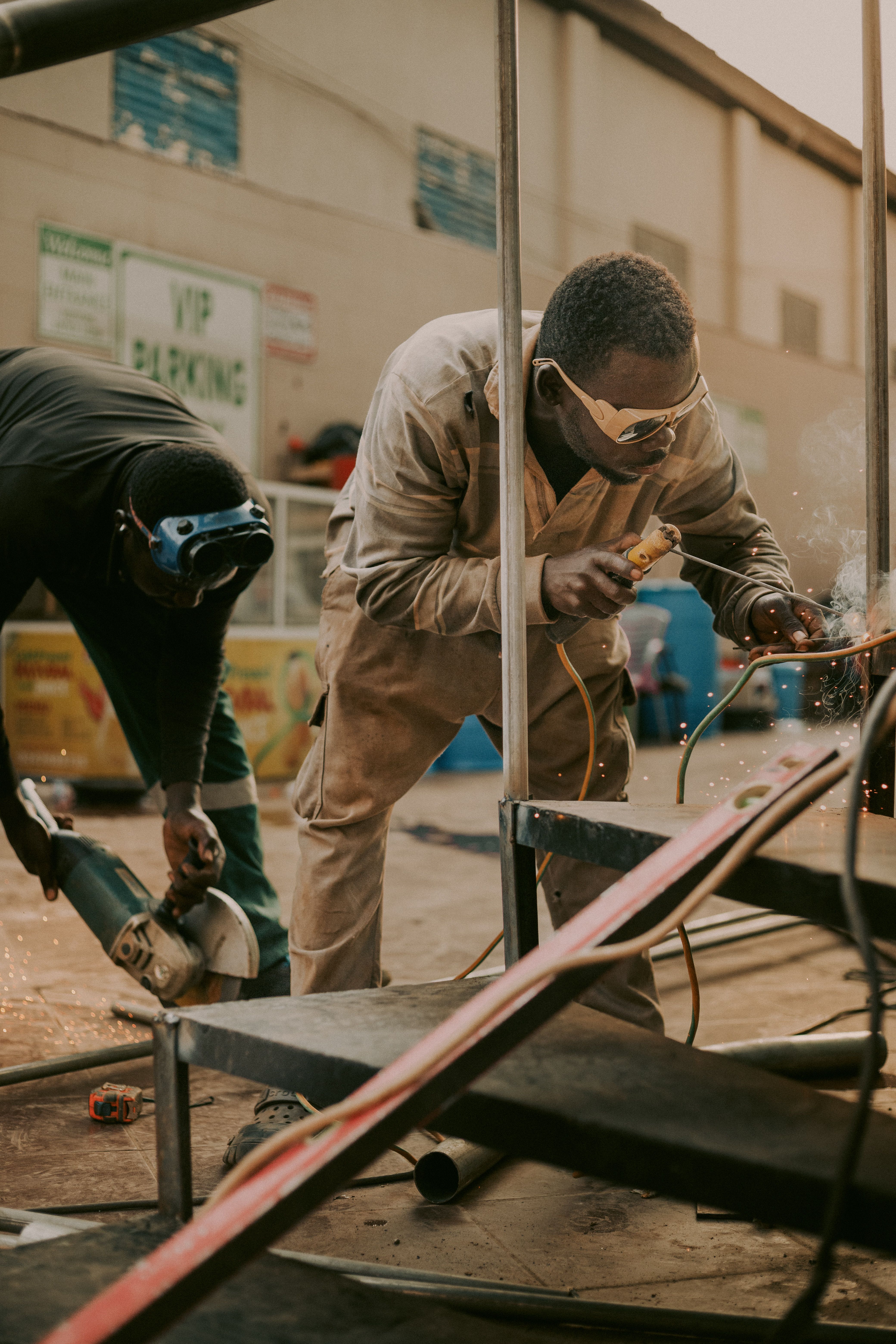 Student grinding metal in a trade workshop